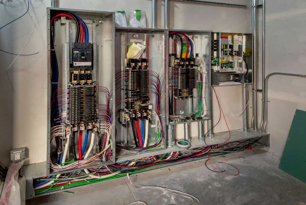 A large electrical panel with neatly dressed, color-coded wiring