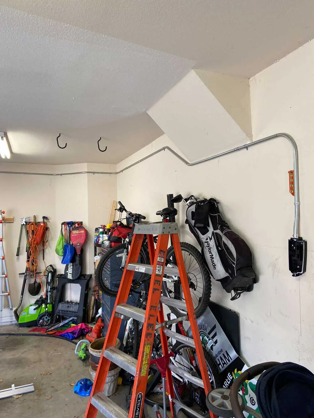 A wall-mounted EV charger installed in a home garage